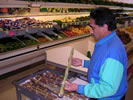 The photo is of one of our inspectors completing an ethnic market inspection.